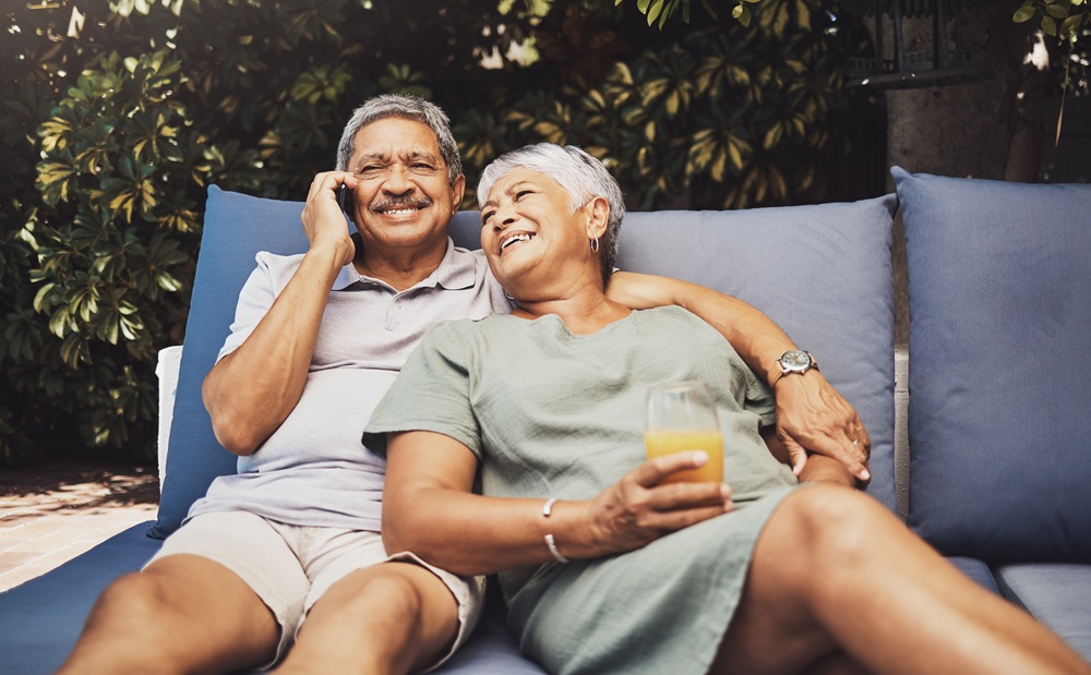 Retired Couple Relaxing Comfortably in Outdoor Living Space – New Construction Guidance Smiling senior couple enjoying outdoor seating area representing comfort achieved through new construction guidance – New Construction Guidance
